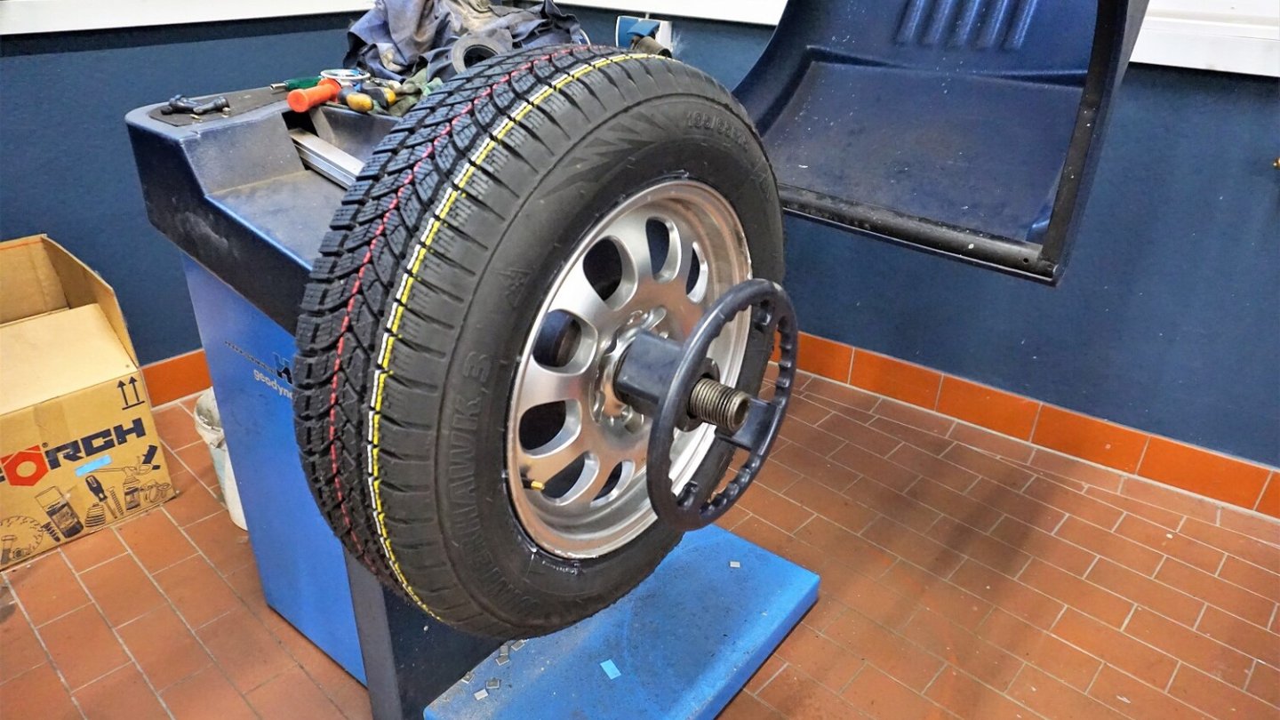 Hier wird ein neuer Reifen ausgewuchtet.