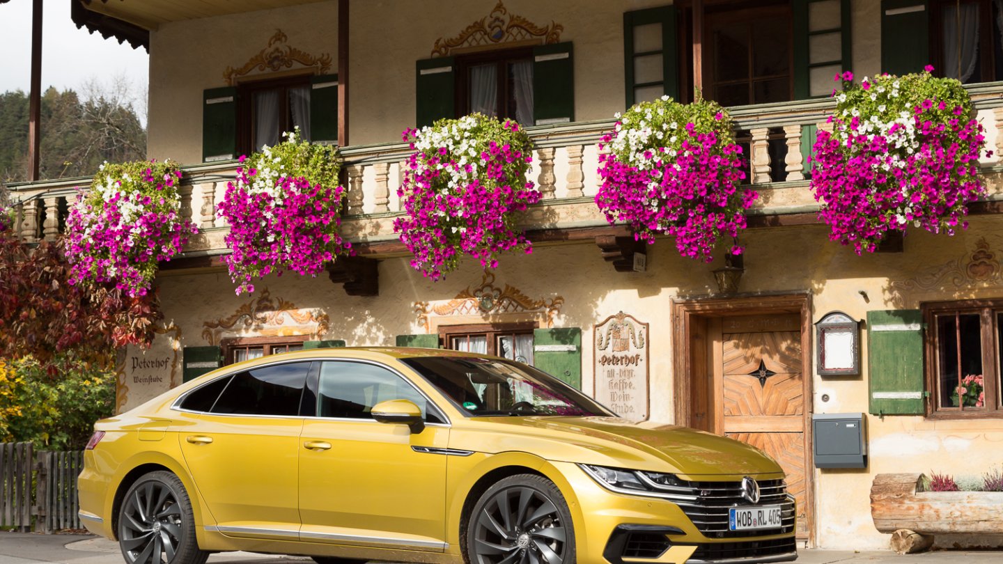 Farbenfroh wie der Blumenschmuck der Pension Peterhof in Bayrisch Zell: der VW Arteon in Kurkumagelb. Foto: Karin Zipperling.